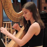 <p>A harpist plays during the Bronxville High School senior baccalaureate June 12.</p>