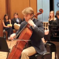 <p>A bass player performs at the Bronxville High School senior baccalaureate June 12.</p>