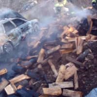 <p>The car fire caused a nearby wood pile to also ignite.</p>