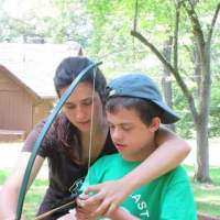 <p>A counselor works with a boy at a summer camp for children with autism and other developmental disabilities. The camp is run by North East Westchester Special Recreation.</p>