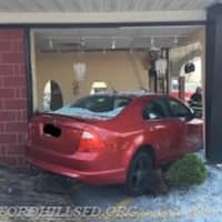 <p>Three people received minor injuries when a car crashed into a building on Bedford Road.</p>