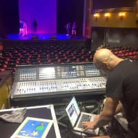 <p>Wall Street Theater Artistic Director Billy Blanks, Jr. checks the sound while the Teen Theater Program rehearses.</p>