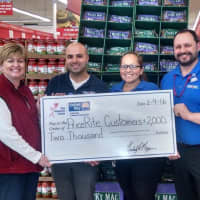 <p>Kim Morgan, left, of the United Way of Western Connecticut presents a check for $2,000 for groceries at PriceRite in Danbury.</p>