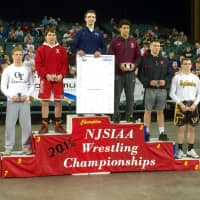 <p>Paramus&#x27; Kyle Cochran stands atop the podium after winning his first state wrestling title.</p>