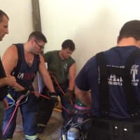 <p>Firefighters practice techniques for rescuing fallen crew members.</p>