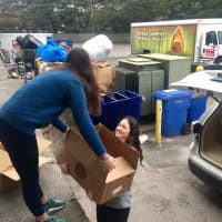 <p>Food &quot;rescuers&quot; volunteers Abby Straight and Emma Straight load a car to make a delivery for Food Rescue US.</p>