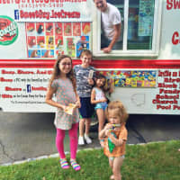 <p>John Monahan with his SweetGuy Ice Cream Truck and some very happy patrons.</p>