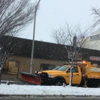 <p>A city snowplow goes to work on Main Street in Danbury on Friday morning near Escape to the Arts.</p>