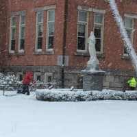 <p>School was canceled but two workers clear the sidewalks Friday around St. Peter&#x27;s School on Main Street in Danbury.</p>