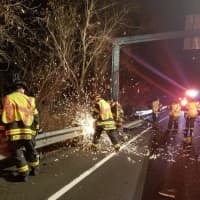 <p>Danbury firefighters cut through a steel guardrail to gain access to a car that went off the highway on I-84</p>