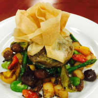 <p>Artichoke bottom stuffed with Wild Mushrooms. Baked in a Phyllo Pastry served with vegetables.</p>