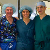 <p>From left, Dr. Lee Eisenberg, Dr. Robin Brody, and Dr. Dan Grinberg volunteer at a facility. </p>