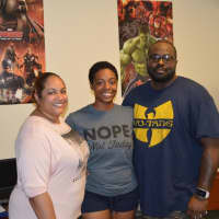 <p>Jelexus Watkins and her parents complete the finishing touches on her dorm room at Fairfield Hall at Western Connecticut State University in Danbury, </p>
