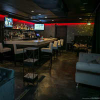 <p>The downstairs bar also features swanky furniture, but there are also dart boards, a pool table and TVs.</p>