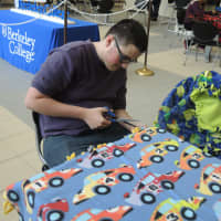 <p>Joshua Henry of Dumont works on a blanket for Project Linus, one of several projects Berkeley College students are involved in to commemorate Martin Luther King Jr. Day.</p>