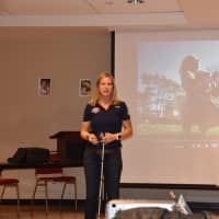 <p>Greenwich paratriathlete Amy Dixon talks about her Guiding Eyes for the Blind dog, Elvis, at Saturday&#x27;s retirement party at the Greenwich YMCA. </p>