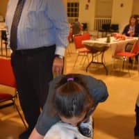 <p>Elvis gets a hug from a girl at the retirement party. </p>