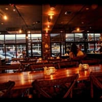 <p>The communal tables at Exit 4 Food Hall on Main Street in Mount Kisco. Service is semi-cafeteria style and there are nine food stations to choose from.</p>