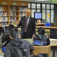 <p>Danbury Mayor Mark Boughton talks to students during a March 22 career fair at Rogers Park Middle School about the different branches of government, the function of Common Council, and taxes.</p>