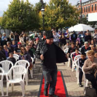 <p>DJ Johnny G struts his stuff down the red-carpet runway during the Fall Food and Fashion show on Saturday at Market Square.</p>