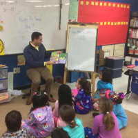 <p>State Representative Michael Ferguson reads to second graders Thursday at King Street Primary School in Danbury.</p>