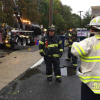 <p>Assistant Chief Sherwood and Lt. Barry of the Fairfield Fire Department work at the scene of the truck accident in Fairfield. </p>