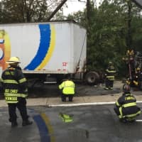 <p>Fairfield firefighters oversee removal of the truck after the accident.</p>