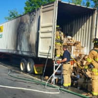 <p>Firefighters tackle the tractor-trailer fire Wednesday afternoon near Exit 9 on I-95 in Stamford.</p>