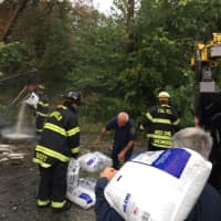 <p>Fairfield firefighters help spread SpeedDry at the scene of the truck accident. </p>
