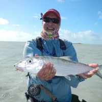 <p>Sekhar Bahadur holds up a bonefish he caught on a recent trip to the Bahamas with staff from The Compleat Angler in Darien.</p>