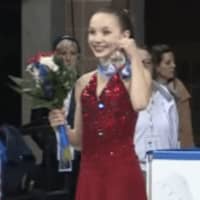 <p>Emilia Murdock shows off her silver medal in Intermediate Ladies from the podium at the national championships for the U.S. Figure Skating Association.</p>