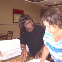 <p>Christine Francis of YAI works with a YAI woman at the DoubleTree hotel in Tarrytown.</p>