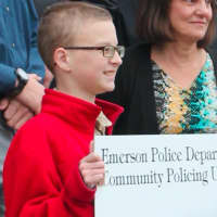 <p>Franklin Praschil, a Boy Scout, accepts a $12,000 check from the local police department for his Eagle Scout memorial garden project. </p>