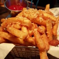 <p>The truffle fries at The Front Porch Pub in Hawthorne are big, crunchy, and sprinkled with parmesan cheese.</p>