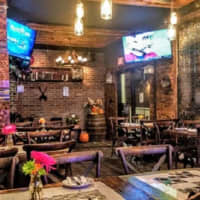 <p>The Front Porch Pub in Hawthorne, N.J., combines the rustic with industrial chic in its updated decor.</p>