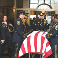 <p>Norwalk police officers prepare to fold a U.S. flag for Lt. Tim Murphy after his Mass of Christian Burial.</p>