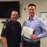 <p>Detective Michael Rooney and Deputy Policer Chief Mark Marino. Marino honored Rooney as Officer of the Month.</p>
