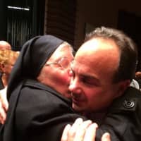 <p>Joe Ganim gets a hug from a nun at his swearing-in ceremony as mayor on Tuesday evening at the Klein Auditorium in Bridgeport. </p>