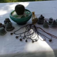 <p>A display of some necklaces, cairns and sweet dream bags created by Darlene Garrison for her business Garnets in the Rough.</p>