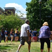 <p>The student, in a line, followed by family and friends, head for the quad on the downtown campus of Western Connecticut State University in Danbury. </p>
