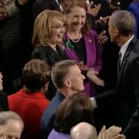 <p>Gabrielle Giffords reaches out to President Barack Obama before the Stat eof the Union Address begins Tuesday night. Giffords, a former Congresswoman and gun violence victim, is sitting with U.S. Rep. Elizabeth Esty (D-Conn., 5th District).</p>