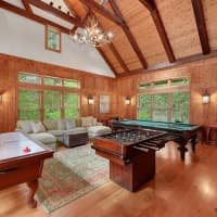 <p>The home&#x27;s game room features massive wooden beams and a view of the propety.</p>