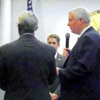 <p>New Fair Lawn Police Officer Brian Goodson is sworn in by Mayor John Cosgrove.</p>