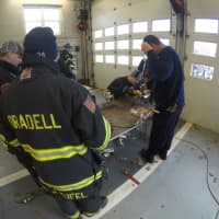 <p>Firefighters practice their skills with power tools.</p>