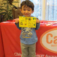 <p>A happy little boy shows the Valentine&#x27;s Day card he made.</p>