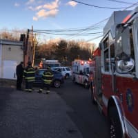 <p>Greenwich first responders on the scene of a vehicle hitting the side of a building Wednesday.</p>