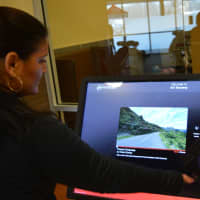 <p>Roxanne Johnson, general manager of 24 Hour Fitness Ramsey, chooses a virtual spinning tour.</p>