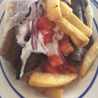 <p>The eponymous gyro is made of meat (normally pork, chicken, beef or lamb) cooked on a vertical rotisserie on a pita and topped with tomatoes, onions and tzatziki sauce made of yogurt, cucumbers and garlic.</p>