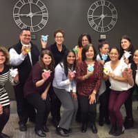 <p>The Berkeley College Online team displays their hand-painted hearts.</p>