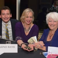 <p>Mary Prenon, center, enjoys the gala with Philip Weiden, left, and Leah Warncke.</p>